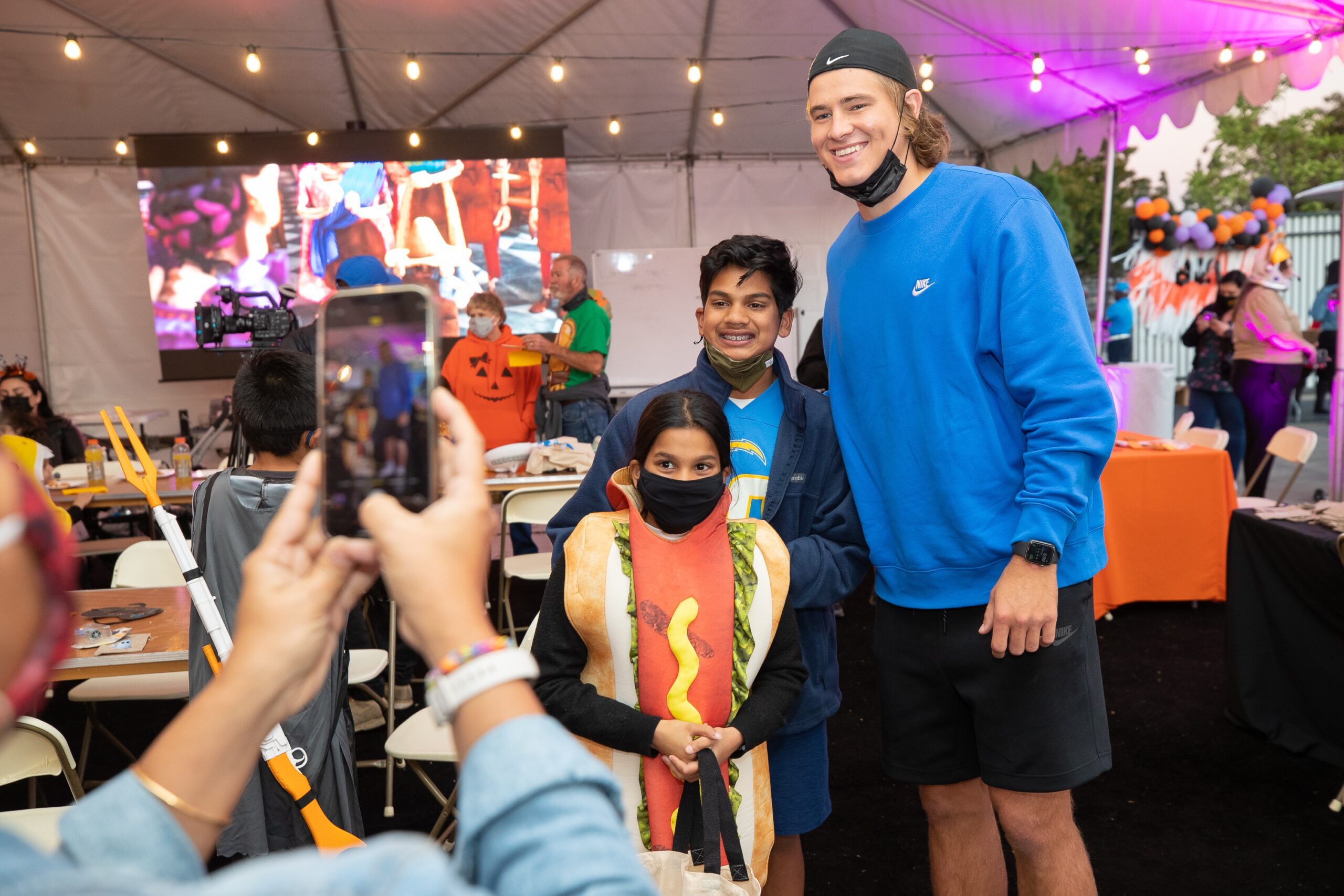 justin herbert smiling with kid