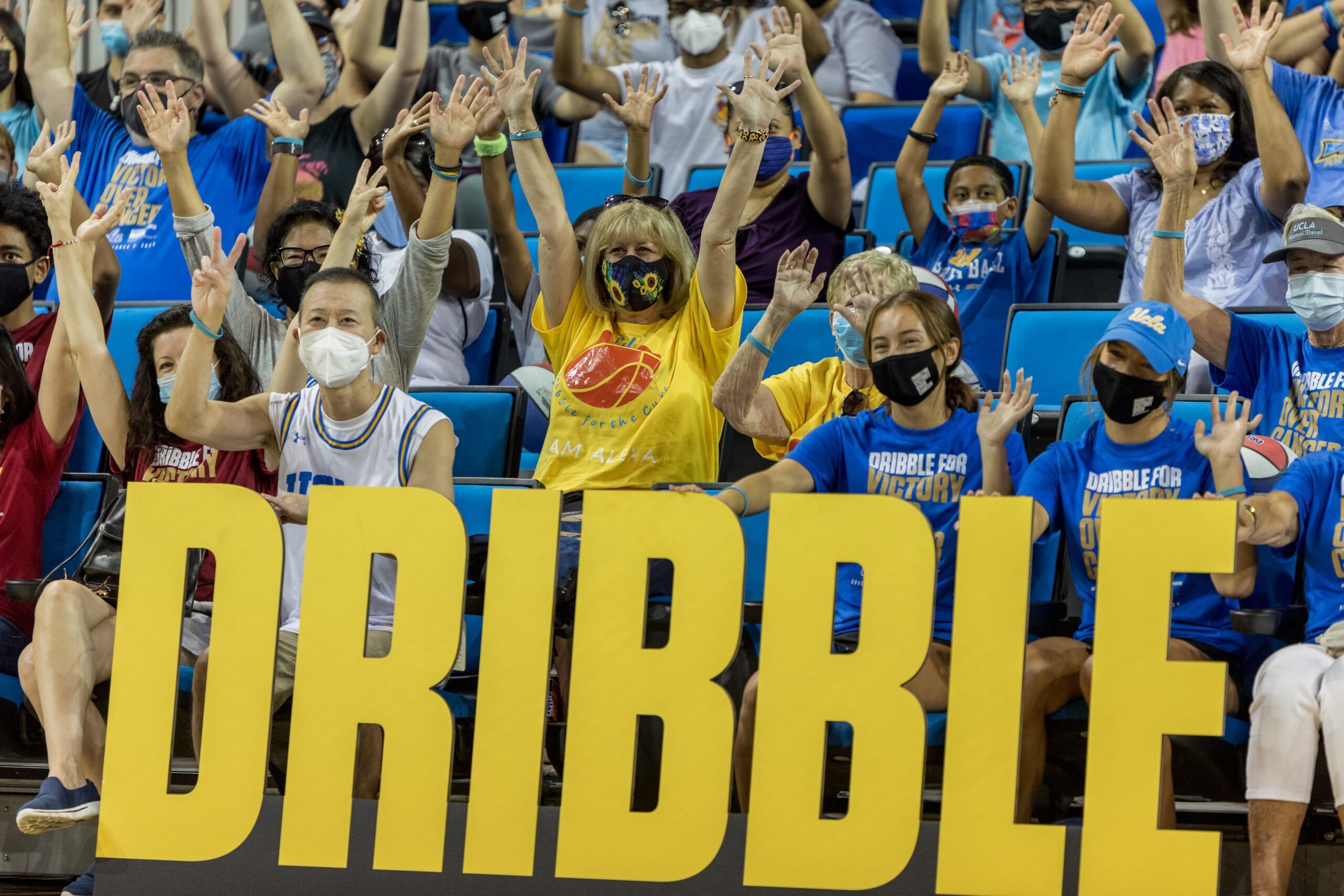 fans holding up peace sign