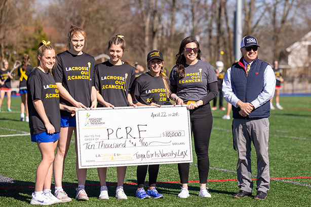 Lacrosse Team Accepting Donation Check